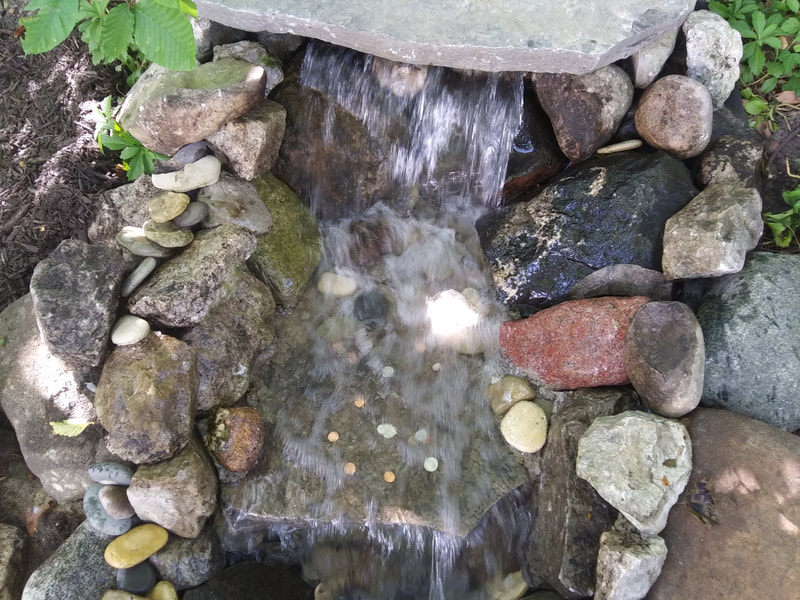 One of our newest guest amenities, a new water feature - waterfall at the newly built deck