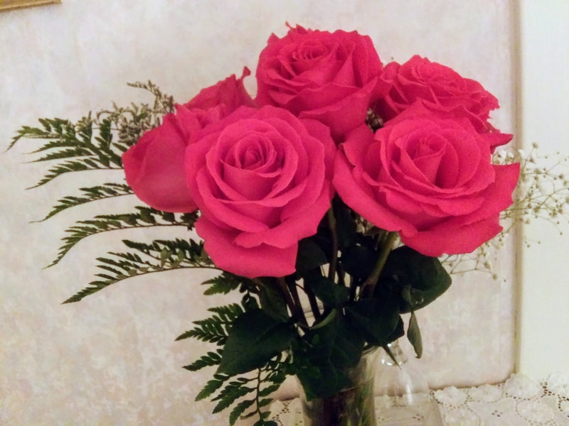 Pretty roses await to surprise a guest.