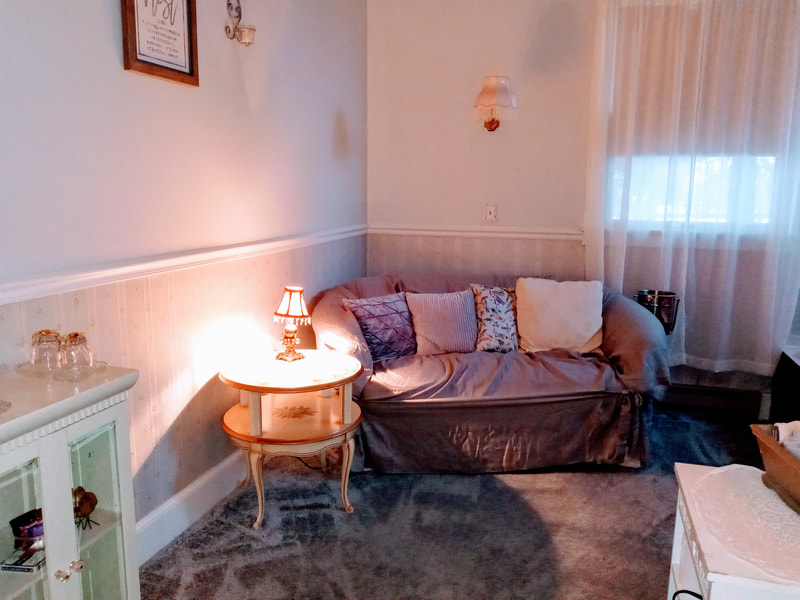 Cuddle up on the loveseat in the Romantic Retreat Suite of the Candlelite Inn Bed & Breakfast.