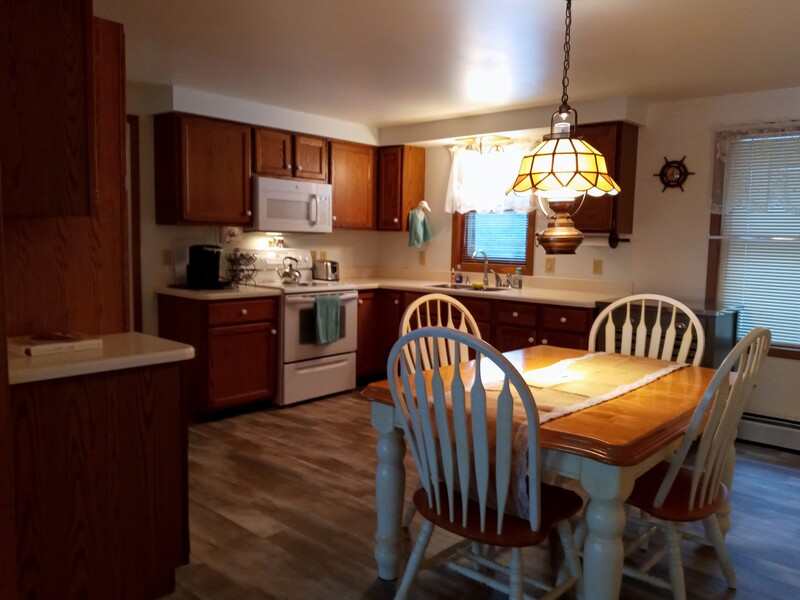 The kitchen has plenty of room for everyone.  There are also two more matching dining chairs and an additional leaf. 