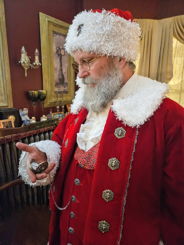 Santa is at the Candlelite Inn Bed & Breakfast. He's checking his watch.