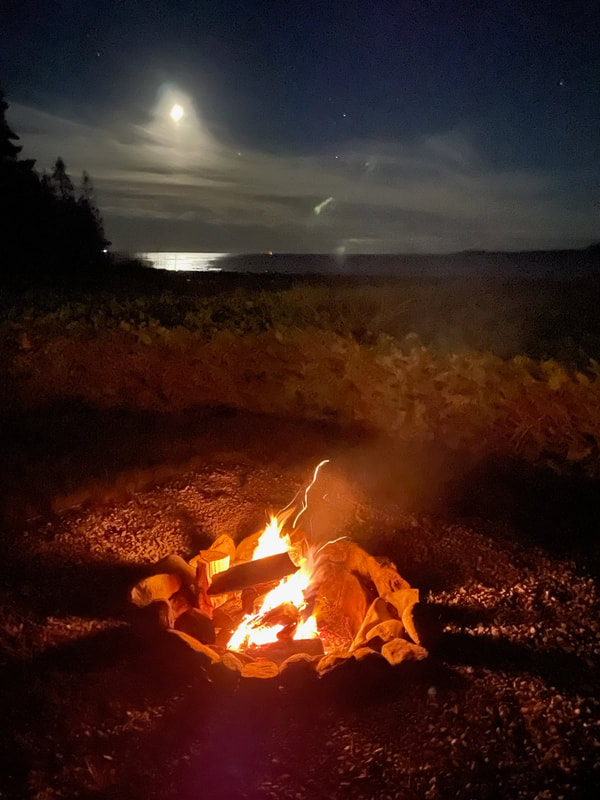 Labor Day guests enjoyed an evening fire with the moon glowing on Lake Huron in the background.