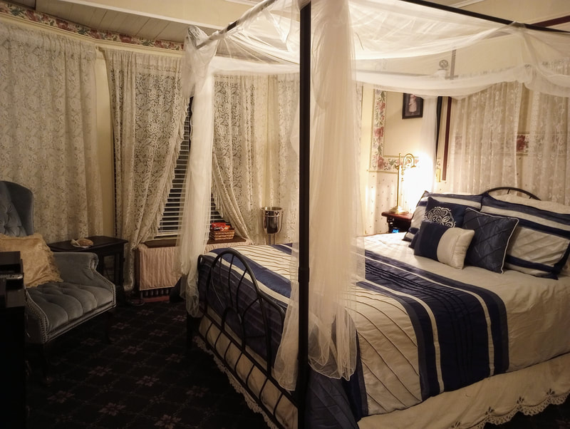 Candlelite Inn's Victorian Room is comfortable and inviting complete with a queen canopy bed.